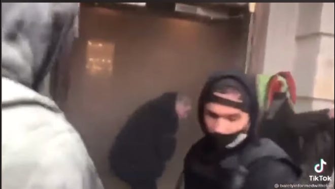 Mike St. Pierre of Fall River is seen here in a still frame from a TikTok video after hurling an object into the building during the Capitol riot on Jan. 6, 2021, in Washington, D.C.