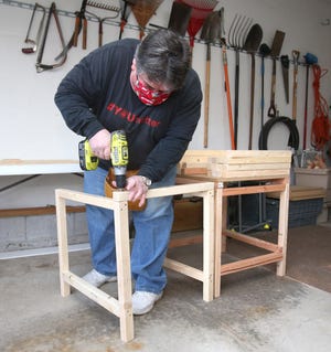 Crenshaw Middle School teacher John Huntsman builds desks in his garage for Canton City students who are learning at home and do not have their own dedicated workspace. He offers the desks to the students for free.