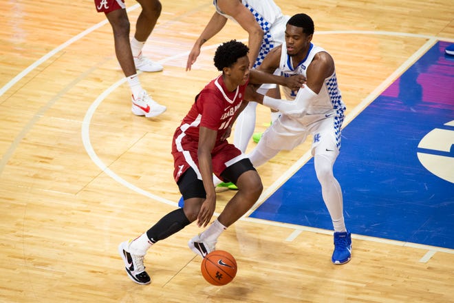Jan 12, 2021; Lexington, Kentucky, USA; Alabama Crimson Tide guard Josh Primo (11) drives against Kentucky Wildcats forward Keion Brooks Jr. (right) during the first half at Rupp Arena at Central Bank Center. Mandatory Credit: Arden Barnes-USA TODAY Sports