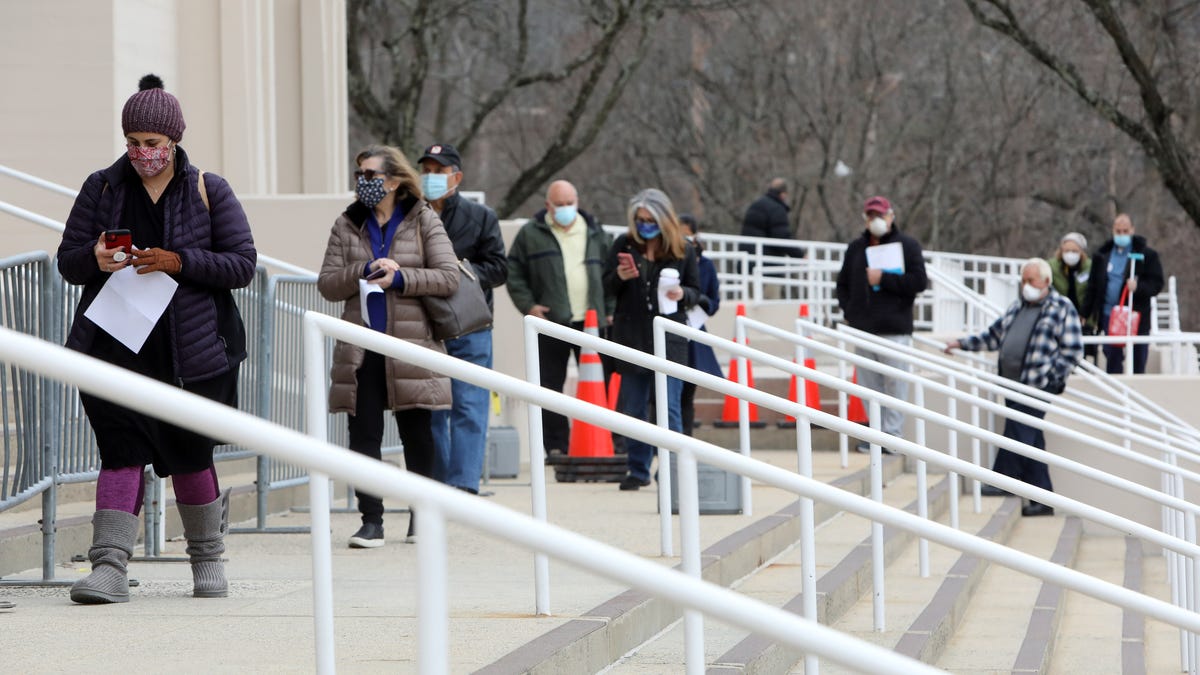 People with appointments for the COVID-19 vaccine wait on line at the Westchester County Center, one of the three mass COVID-19 vaccination sites that opened in New York state today, Jan. 13, 2021 in White Plains. 
