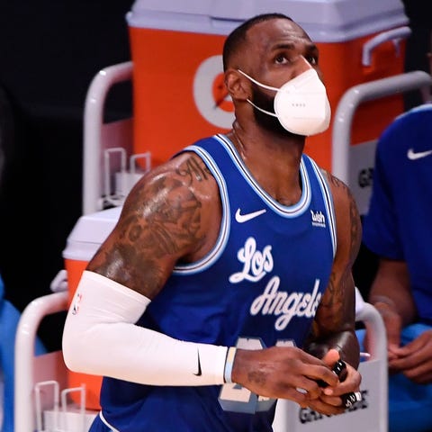 LeBron James wears a mask and heads to the scorer'