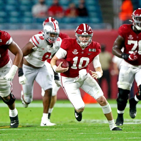 Alabama quarterback Mac Jones runs against Ohio St