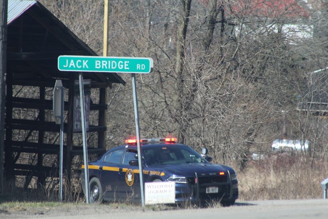 State Police monitor the entrance to Jack Bridge Road in the Town of Willing after the discovery of a body at the edge of the Genesee River. Nicholas A. Burdge, 23, of Wellsville was later identified as the deceased.