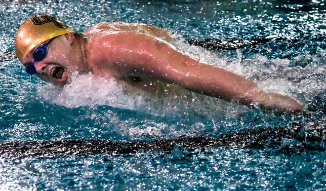 Garden City High School's Connor Cupp comes up for a breath as he makes a stroke in the 100-yard butterfly in December 2019 during a home triangular at the Garden City Family YMCA.