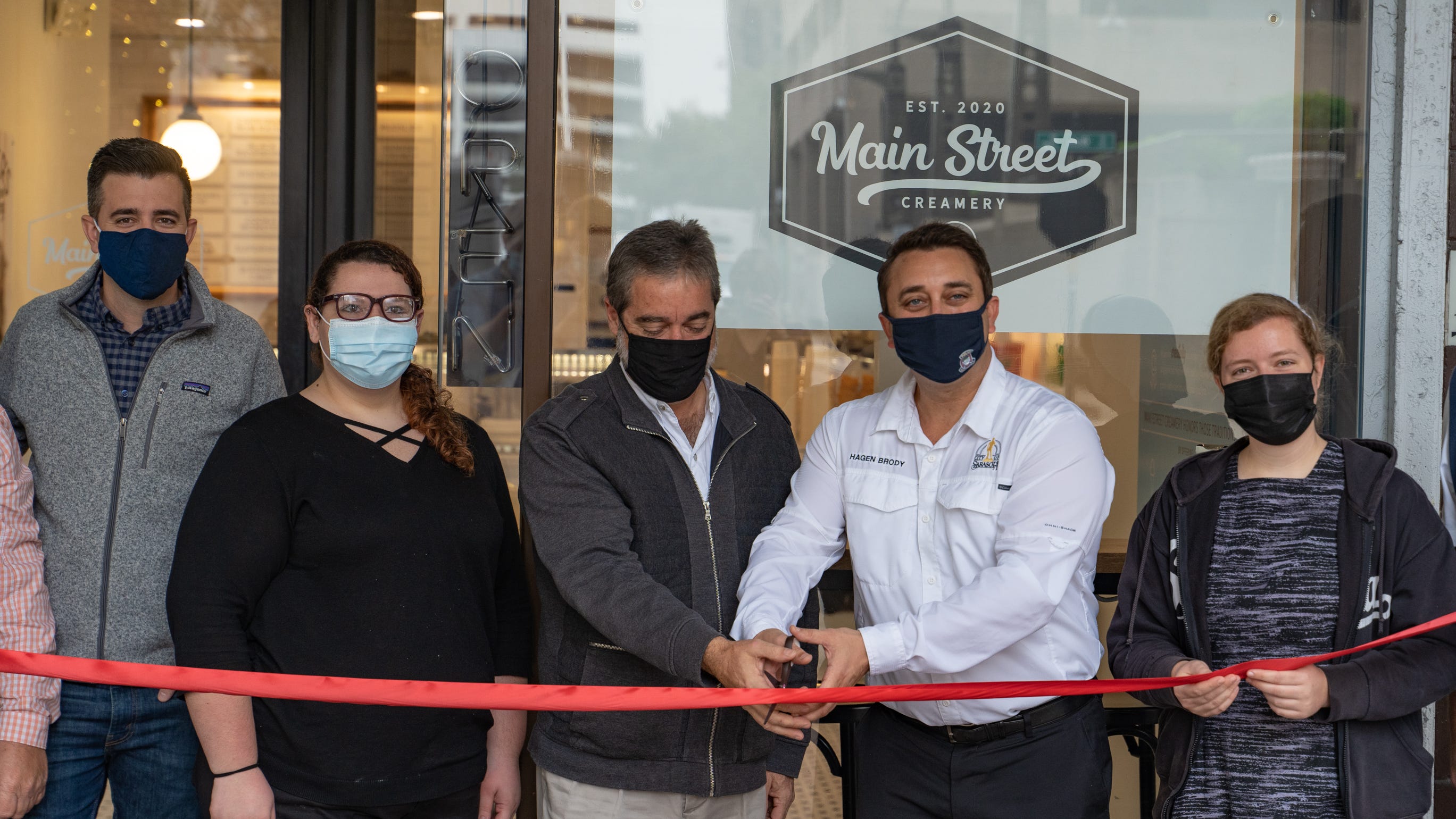 Ice cream shop Main Street Creamery is now open in downtown Sarasota, with Mayor Hagen Brody, second from right, attending a ribbon cutting.