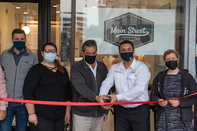 Ice cream shop Main Street Creamery is now open in downtown Sarasota, with Mayor Hagen Brody, second from right, attending a ribbon cutting.