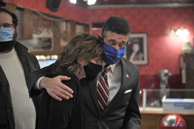 Congressman David Kustoff hugs Juanita Shaw, the widow of Clark Shaw, after presenting her and son Brooks with a flag that was flown over the U.S. Capitol to honor Clark's memory.