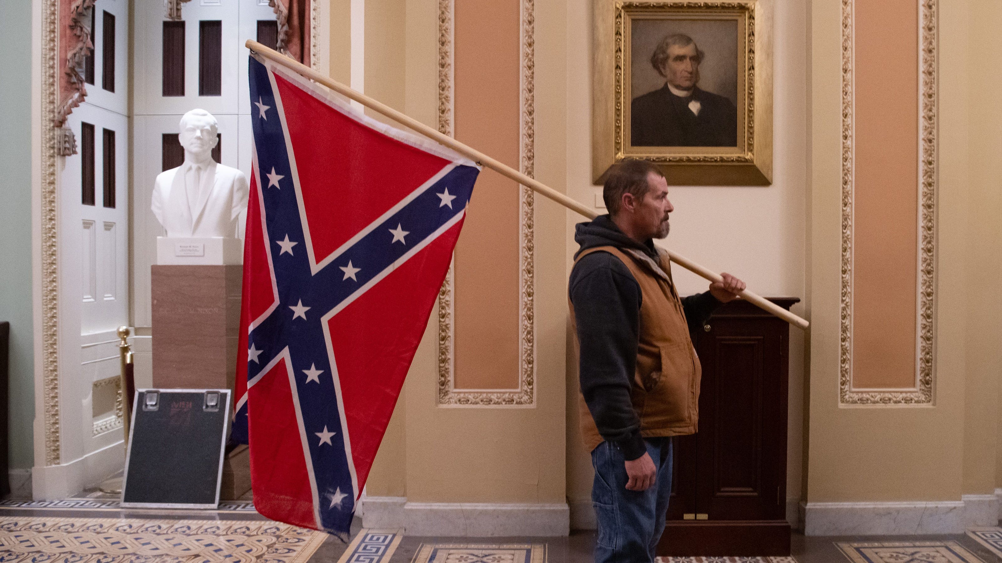 Man seen carrying Confederate flag in Capitol riot arrested