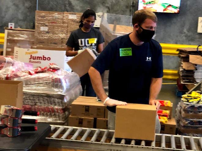 Volunteers box food up for distribution at the Second Harvest warehouse in Orlando.