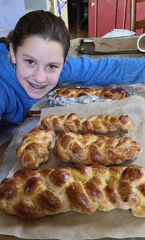 Tahlia Weaver, of Canton, shows the challah she made during a virtual Sunday Funday activity.