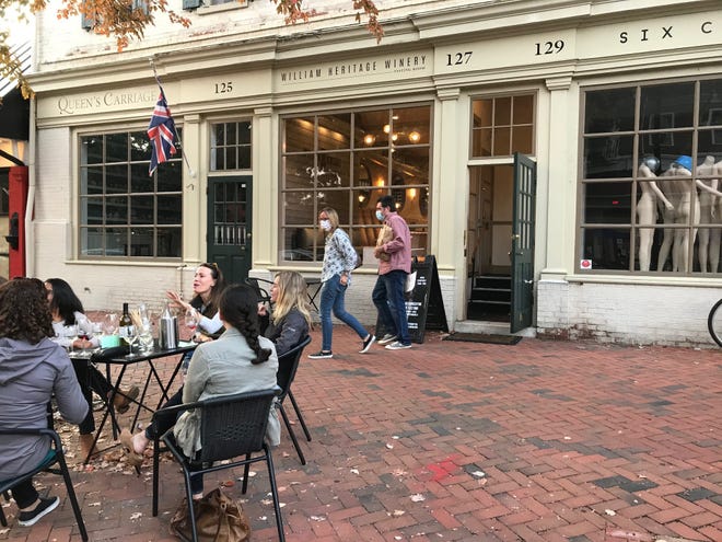Some customers at William Heritage Winery's tasting room on Kings Highway in quaint Haddonfield drink wine outdoors in late fall, while others drink inside or buy wine to go.