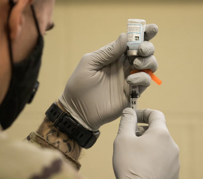 Alabama National Guard Medical Detachment Soldier preparing a does of COVID-19 vaccine on Jan. 7, 2021.