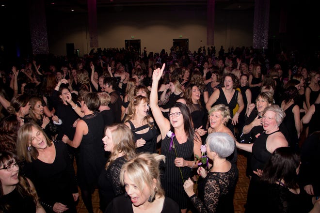 Women dance at a past Blue Water Little Black Dress event at the Blue Water Convention Center.