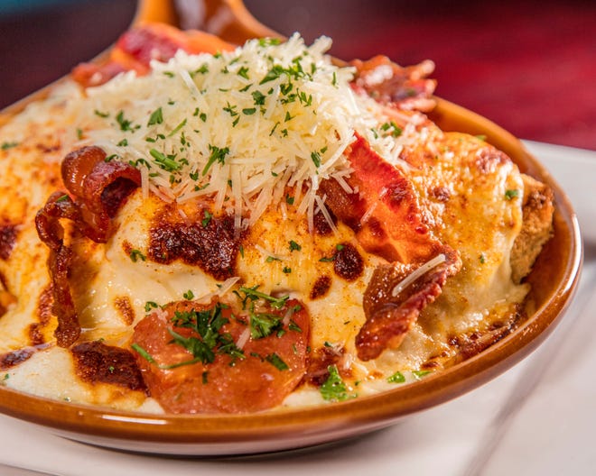 The Kentucky Hot Brown heaps cheese, Roma tomatoes, turkey breast and bacon on a slab of Texas toast.