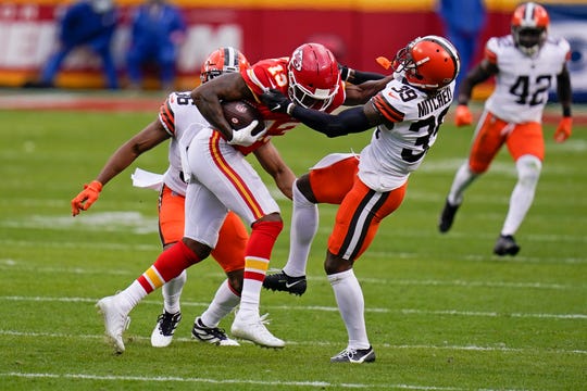 Kansas City Chiefs wide receiver Byron Pringle (13) is tackled by Cleveland Browns cornerback Terrance Mitchell (39) after catching a pass during the first half of an NFL divisional round football game, Sunday, Jan. 17, 2021, in Kansas City. (AP Photo/Jeff Roberson)