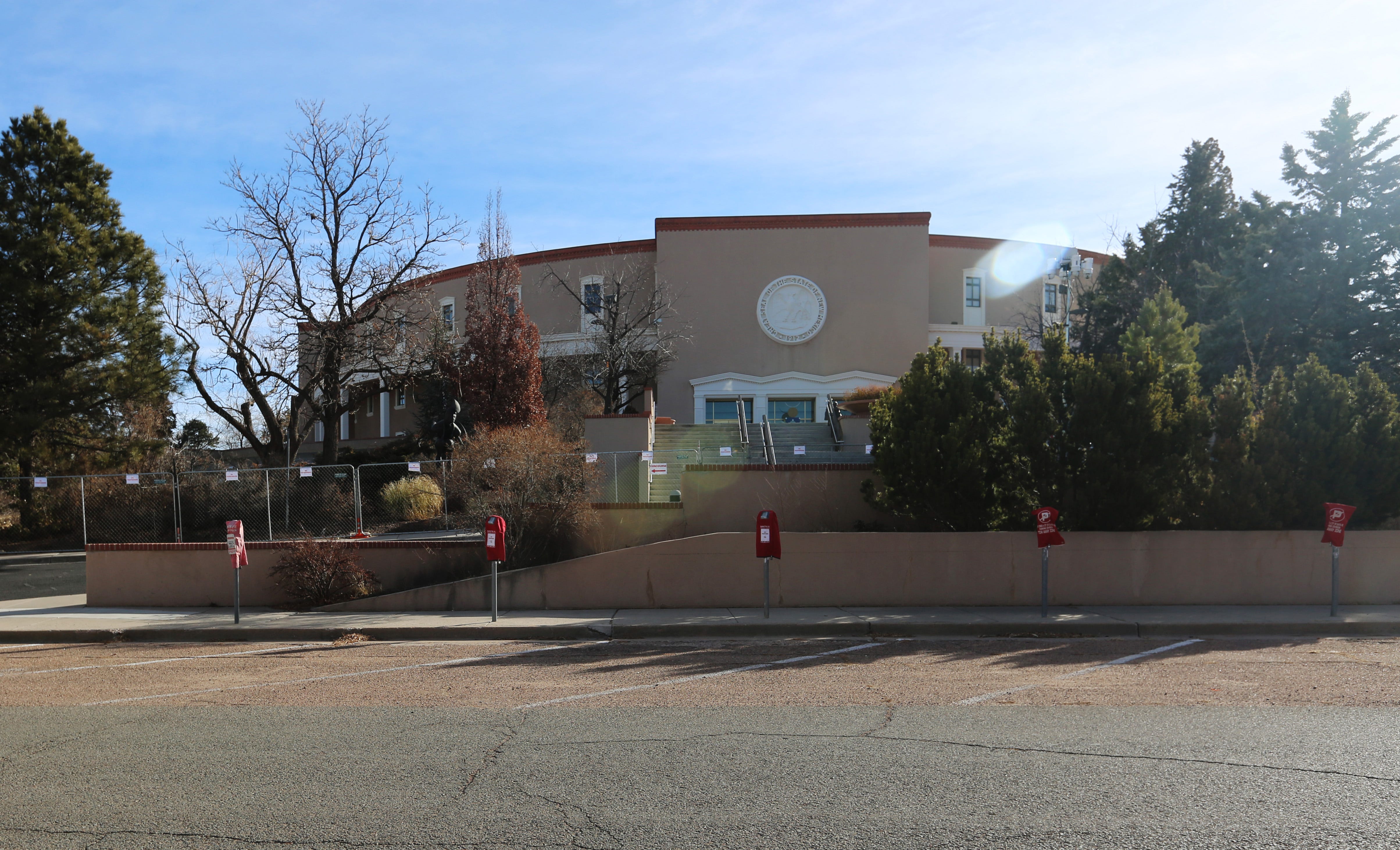 Fencing surrounds an empty Roundhouse, New Mexico's capitol building, in Santa Fe as a safety precaution on Sunday, Jan. 17, 2021. Expected protests did not materialize.