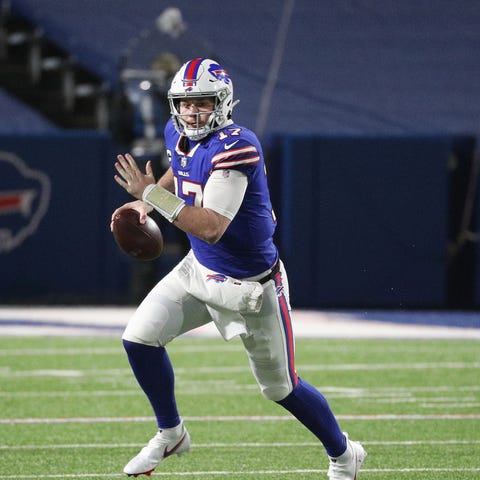 Bills quarterback Josh Allen rolls to his right ag