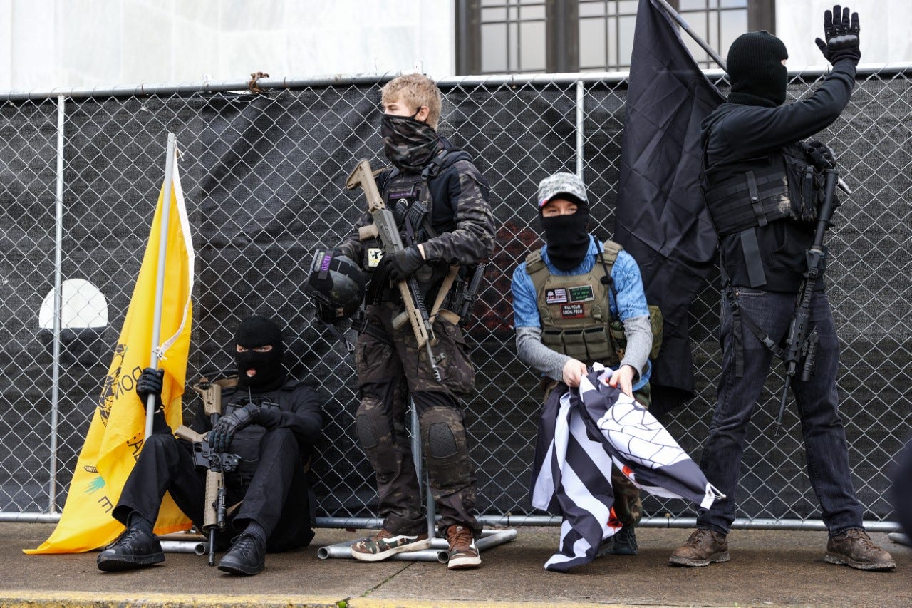 Members of a small group of protesters in front of the Oregon Capitol on Sunday, Jan. 17, 2021.