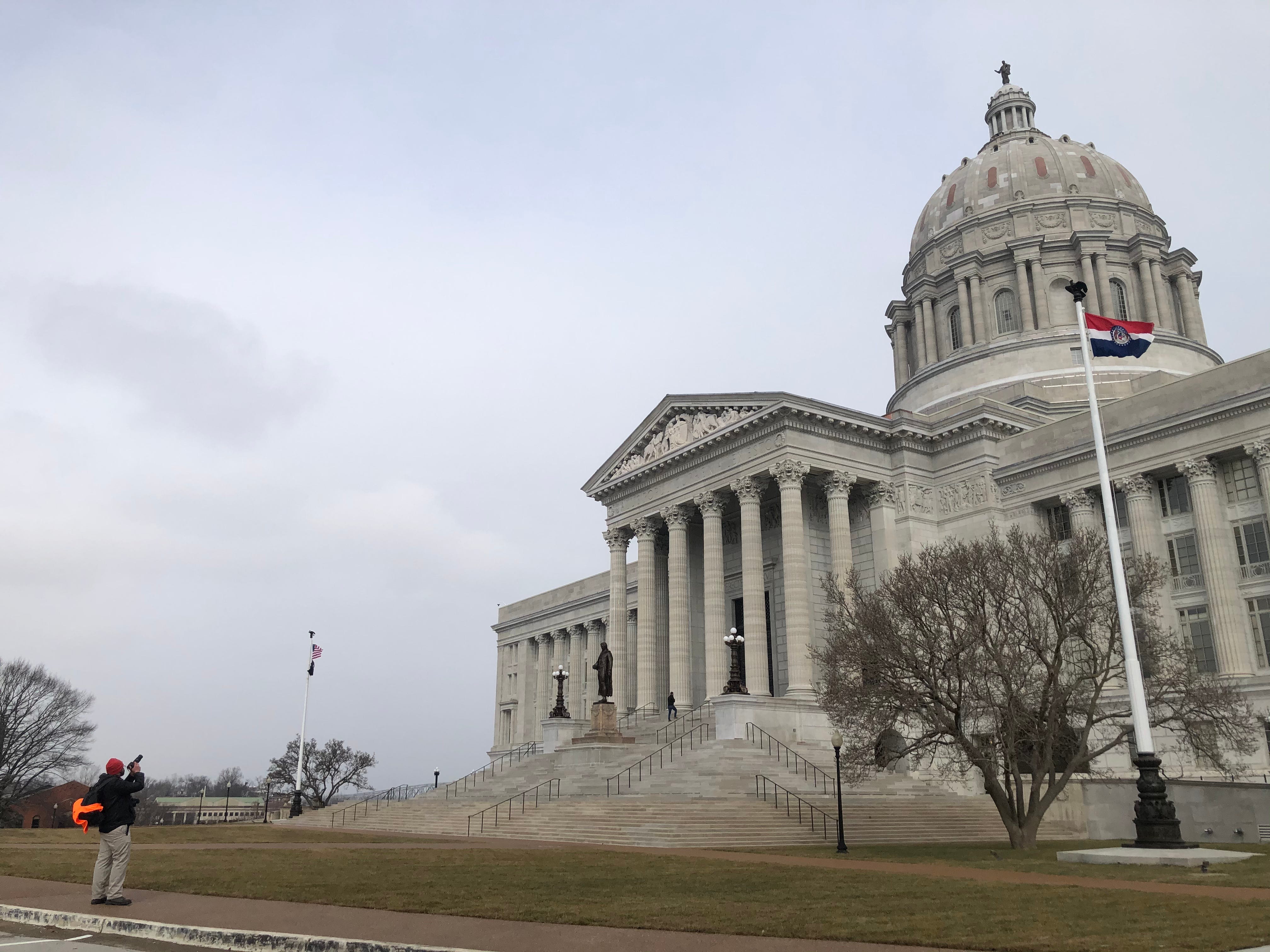 A photographer takes a photo at a largely deserted Missouri Capitol in Jefferson City on Sunday, Jan. 17, 2021.