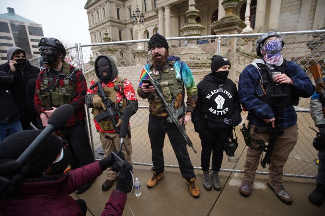 People wearing Boogaloo Bois symbols, during a protest outside of the Michigan State Capitol in downtown Lansing on Sunday, Jan. 17, 2021.