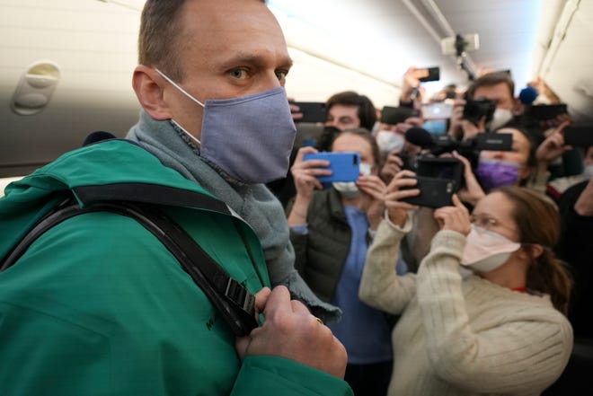 Alexei Navalny is surrounded by journalists inside the plane prior to his flight to Moscow from Berlin on  Jan. 17, 2021.