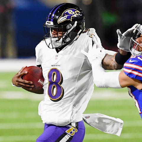 Baltimore Ravens quarterback Lamar Jackson stiff-a