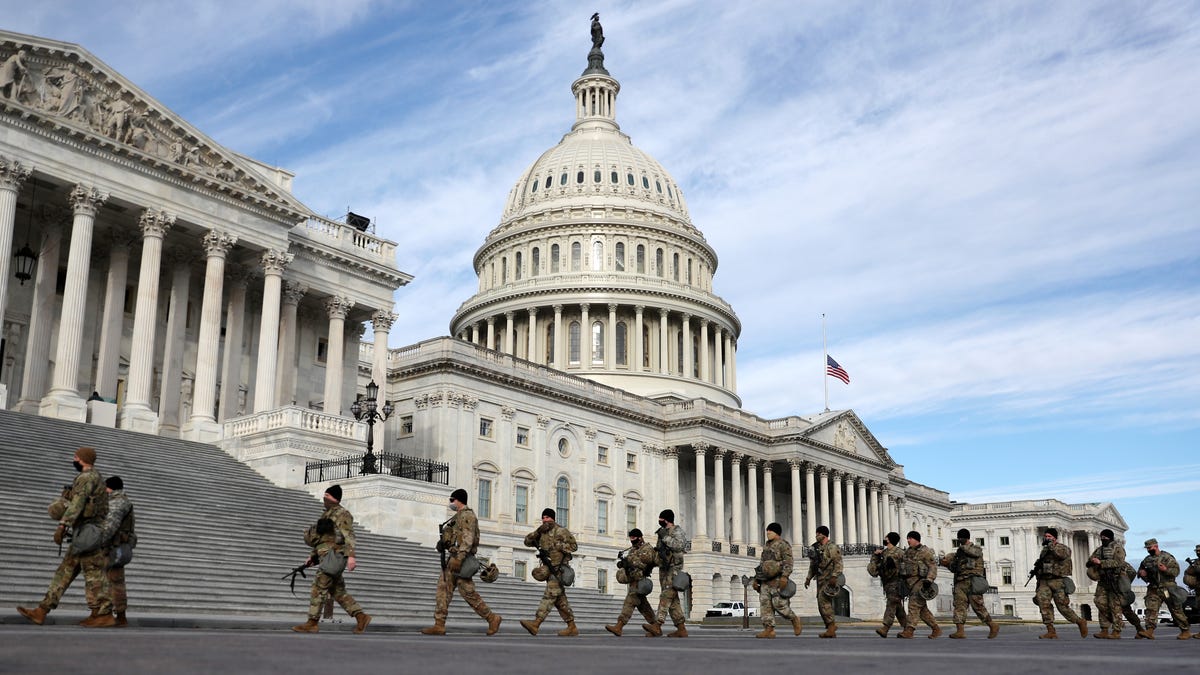 Members of Virginia National Guard walk by the U.S. Capitol on Jan 17, 2021 in Washington, DC. After last week's riots at the U.S. Capitol Building, the FBI has warned of additional threats in the nation's capital and in all 50 states. According to reports, as many as 25,000 National Guard soldiers will be guarding the city as preparations are made for the inauguration of Joe Biden as the 46th U.S. President.