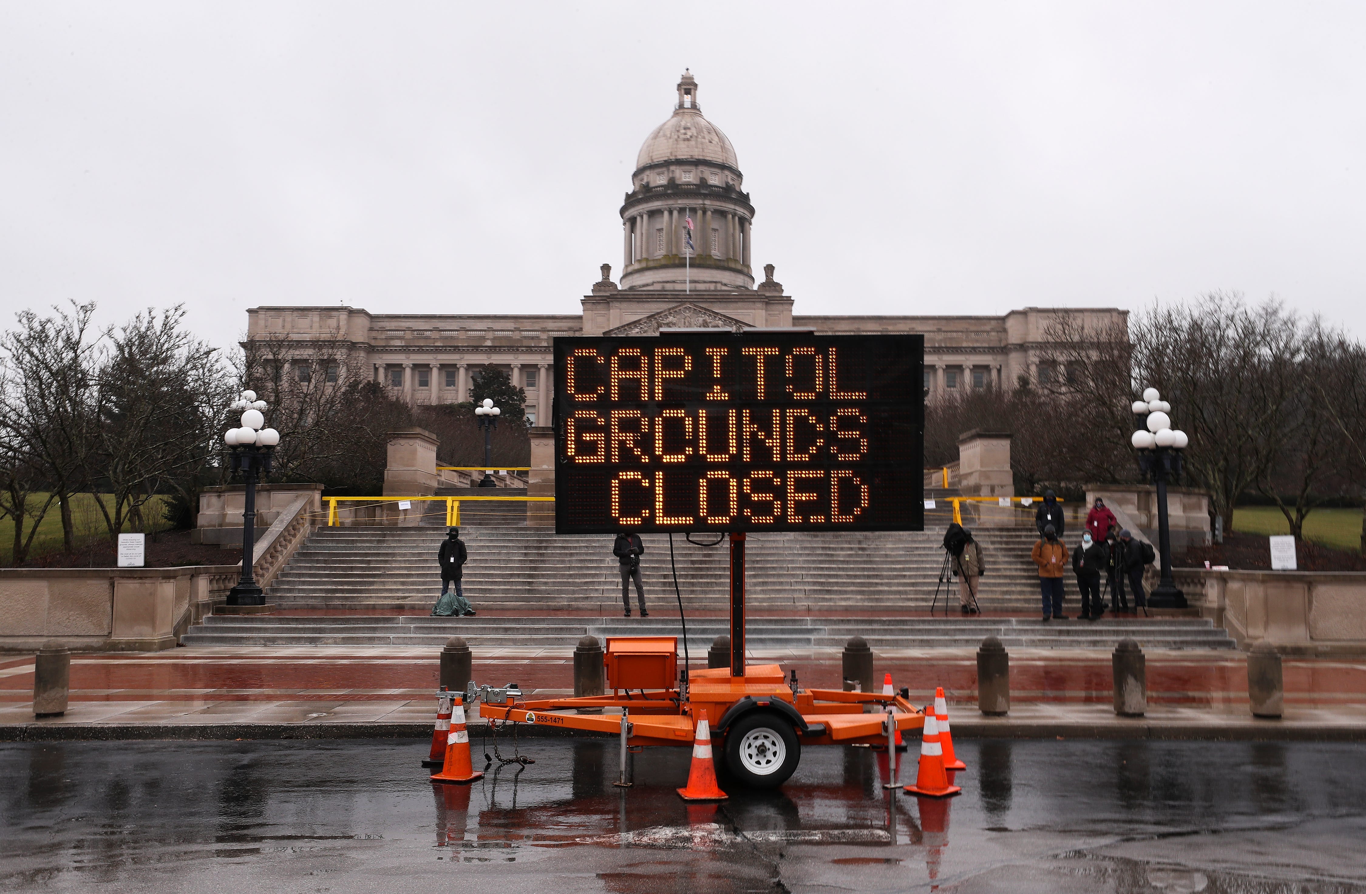 A sign notifying the public that the Kentucky State Capitol grounds are closed to the public is displayed outside the Capitol building in Frankfort, Ky., on Sunday, Jan. 17, 2021.