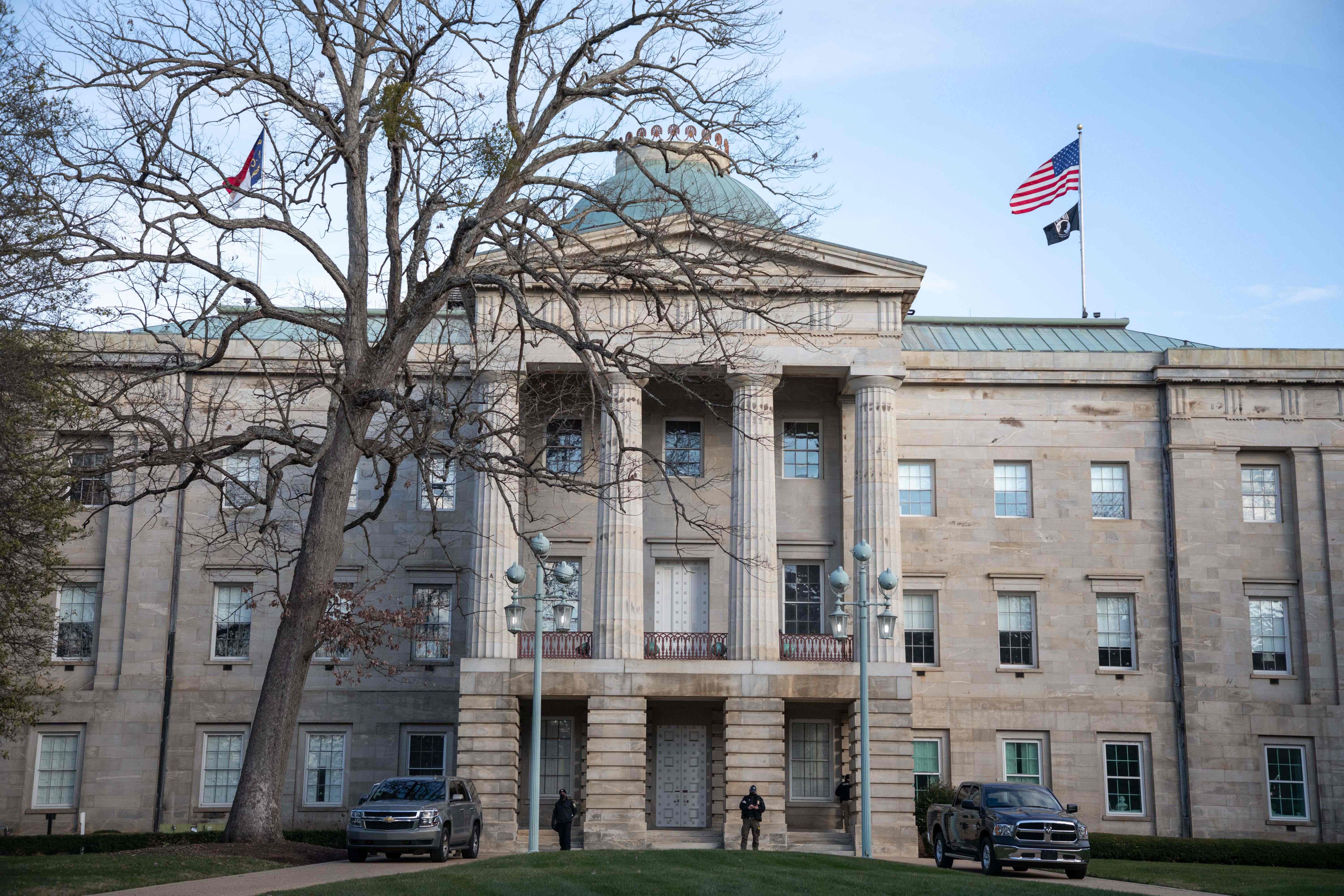 Law enforcement stand guard outside of the state capitol building in downtown Raleigh, N.C., on Sunday, Jan. 17, 2021.