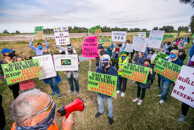 Valencia Reserve residents march in protest against a lake and possible water-ski park next to their west Boynton community.