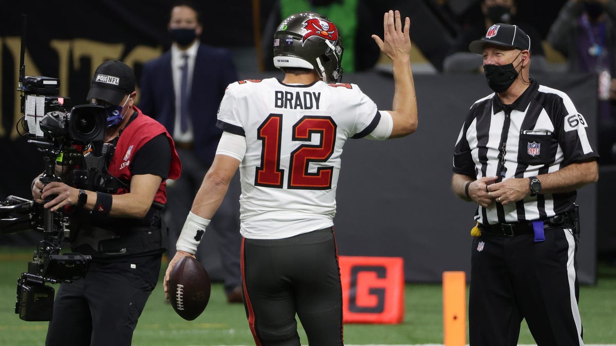 Tampa Bay Buccaneers quarterback Tom Brady tries to get a high five from an official after scoring a touchdown against the New Orleans Saints.