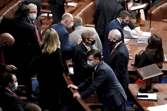Rep. Jim Jordan, R-Ohio, speaks to House Minority Whip Steve Scalise (center-right), R-Metairie, as a joint session of Congress convenes Jan. 6 to confirm the Electoral College votes cast in November's election at the Capitol in Washington.