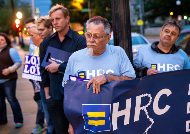 Buff Carmichael, center, along with his late husband, Jerry Bowman, right, during a "prayer sojourn" sponsored by San Francisco-based LGBT activism group Human Rights Campaign in front of the Cathedral of the Immaculate Conception in 2014. The vigil was held to send a message of acceptance in the Catholic Church for the LGBT community during the Vatican's Extraordinary Synod. [Justin L. Fowler/The State Journal-Register]