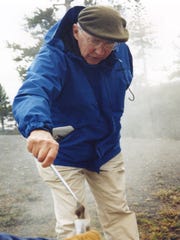 Tom Brock collects a sample from a hot spring in Yellowstone National Park in 1995. A pioneer in his field, Brock's discovery of bacteria that can live in extremely high temperatures led to major advancements in biology and medicine, including the technology that is used in COVID-19 PCR tests.