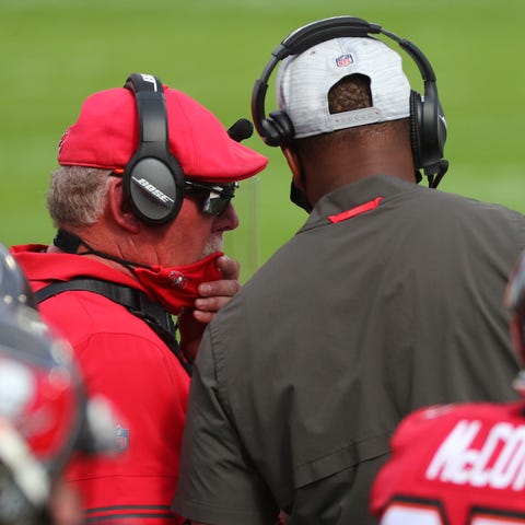 Buccaneers head coach Bruce Arians talks with offe