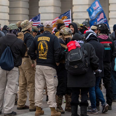 A group of men, some of whom are wearing "Oath Kee