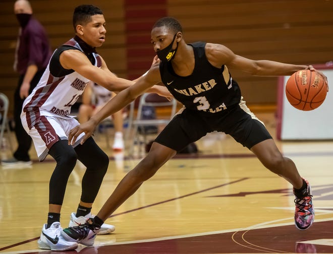 Quaker Valley's Amadou Theiro (3) gets fouled by Ambridge's Montaz Wellons during their game Tuesday at Ambridge Area High School.