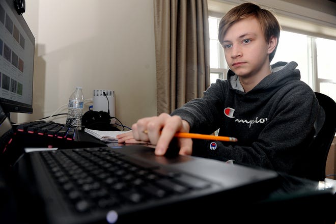 Jake Martel, 14, an eighth-grader at Cameron Middle School in Framingham, participates in a remote geometry class at home, Jan. 20, 2021.