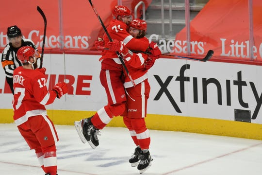 Red Wings' Tyler Bertuzzi celebrates with Dylan Larkin after scoring in overtime Tuesday, giving Detroit a 3-2 victory over Columbus at Little Caesars Arena.