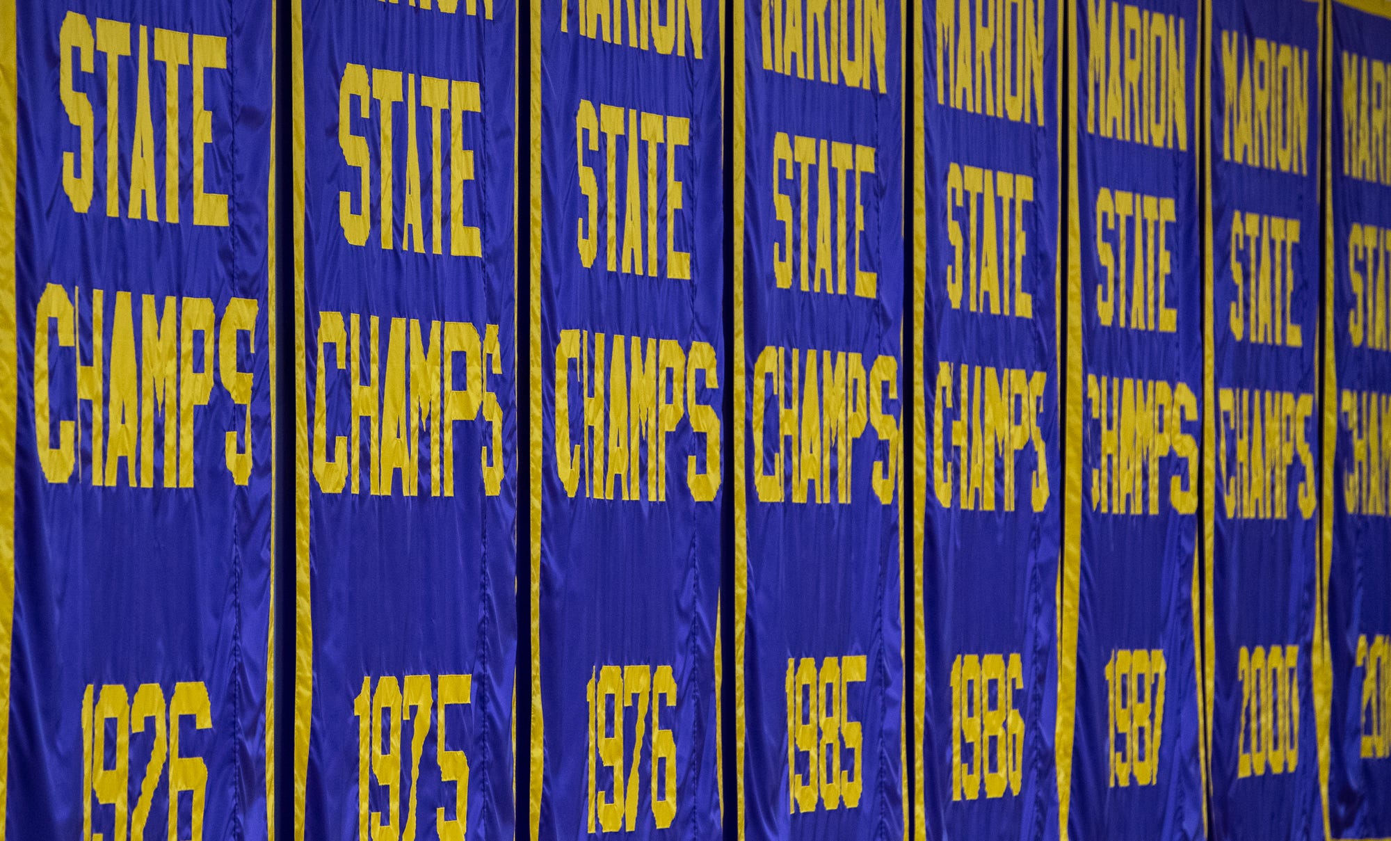 Eight state champion banners fly inside Marion High School's Bill Green Arena on Friday, Feb. 28, 2020.