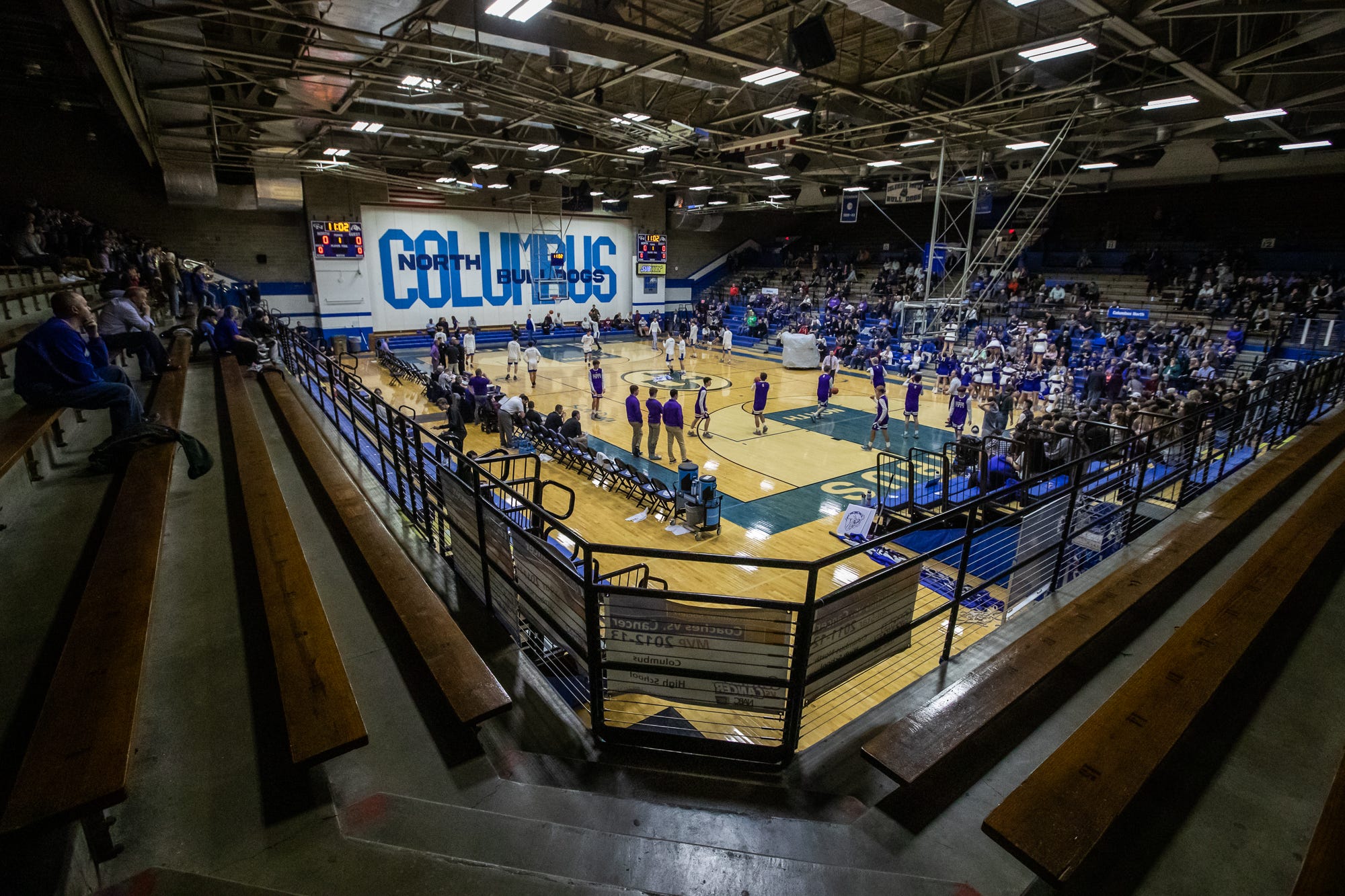 Fans watch as the Columbus North Bull Dogs warm up for their varsity game against the Seymour Owls at the school's Memorial Gymnasium on Tuesday, Feb. 25, 2020.