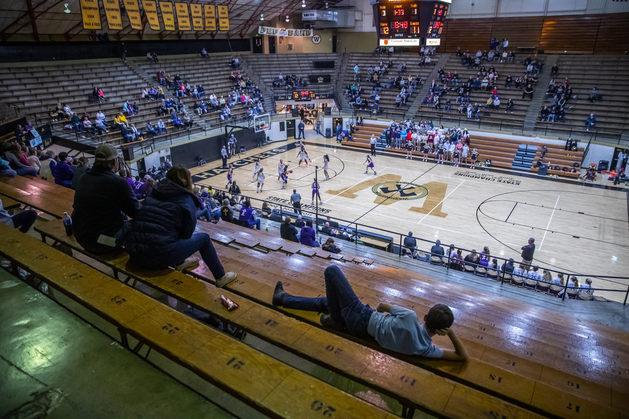 Beckitt McGuyer, 10, gets comfortable during the start of the Washington Hatchets' girls varsity game against the Vincennes Rivet Patriots at Washington High School's Hatchet House on Thursday, Jan. 23, 2020.