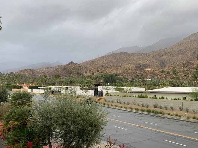 Gray clouds are visible along South Palm Canyon Drive in Palm Springs Wednesday, Jan. 20, 2021. Forecasters said a passing storm weakened and was expected to bring light amounts of rain to the desert.