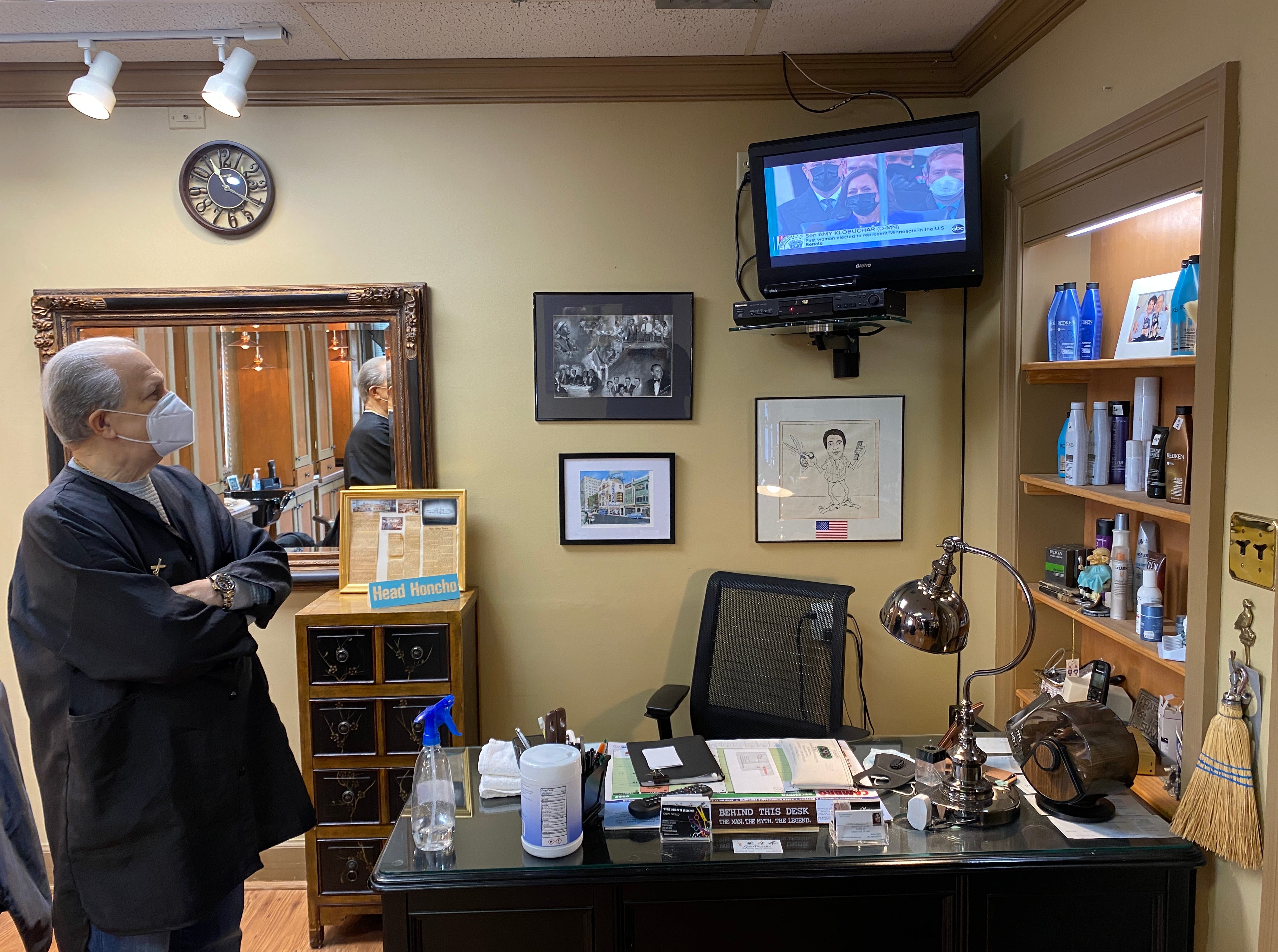 Joe Pacello watches the inauguration from at The Men's Room barbershop in Greenville, where he has cut the hair of the newly-elected president, Joe Biden.