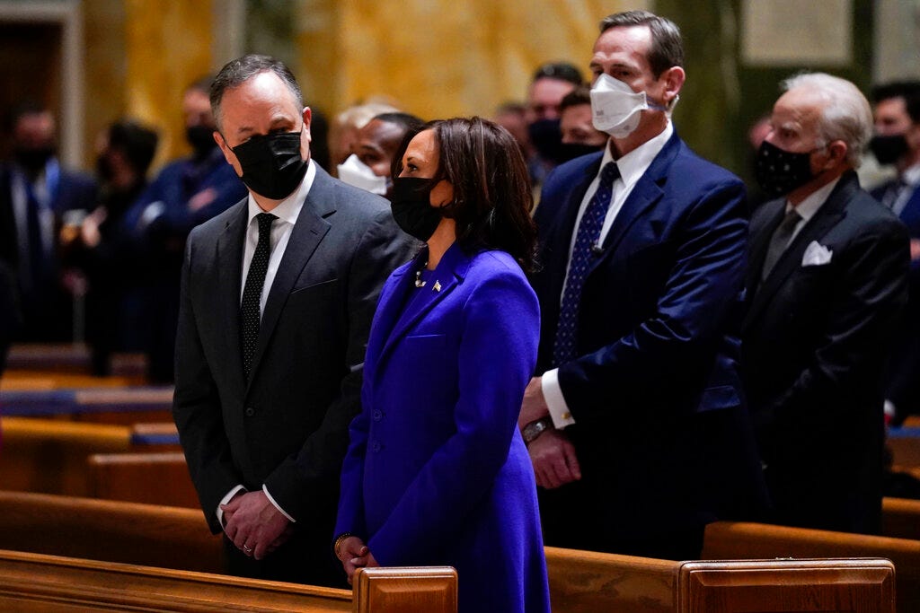 Doug Emhoff looks at his wife Vice President-elect Kamala Harris as they attend Mass at the Cathedral of St. Matthew the Apostle during Inauguration Day ceremonies Wednesday, Jan. 20, 2021, in Washington.