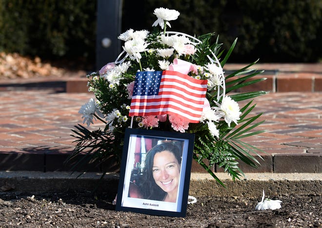 A group of men held a vigil for Ashli Babbitt, the woman who was killed after pro-Trump rioters stormed the U.S. Capitol in Washington, at the Legislative Mall in Dover, Del., on Wednesday, Jan. 20, 2020.