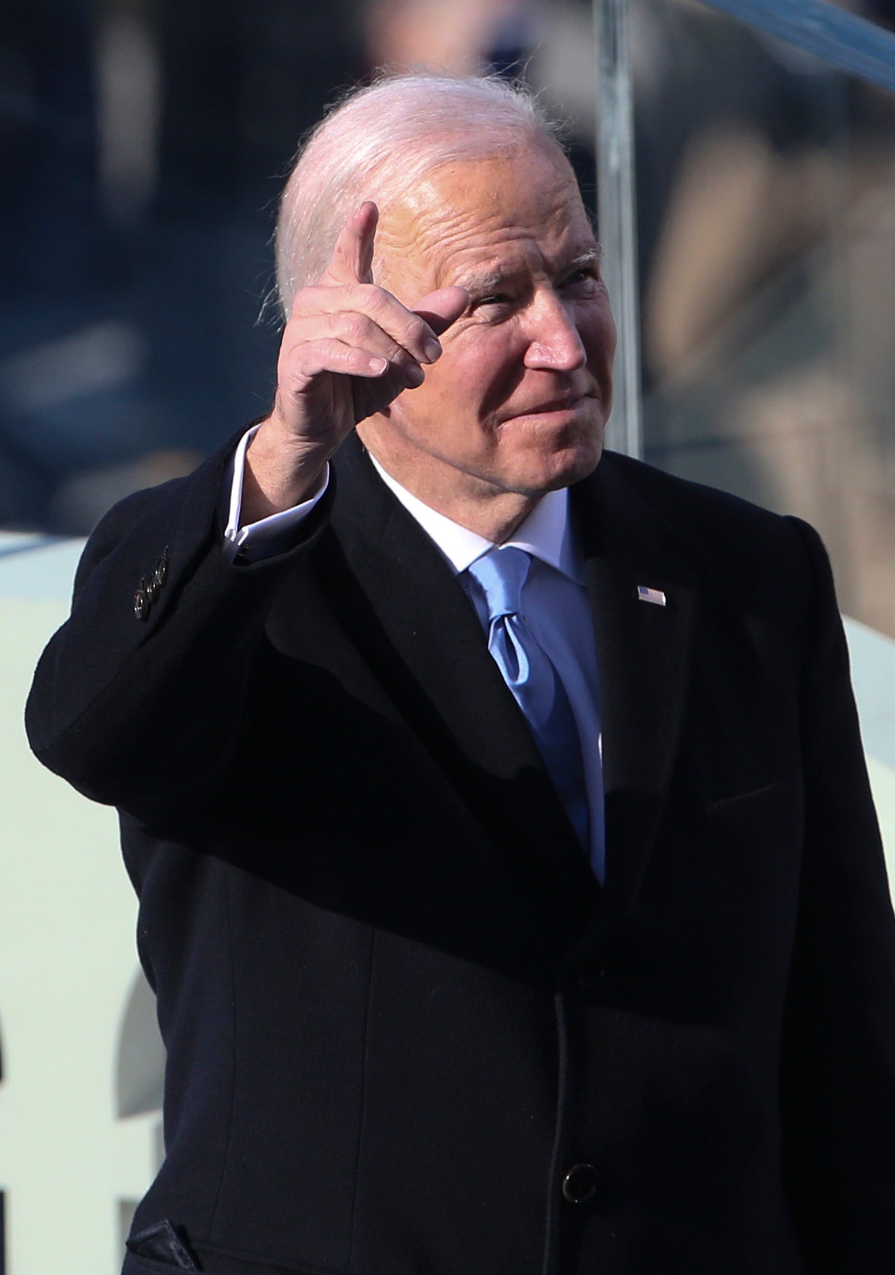 President Joe Biden gestures to crowd members after taking the oath of the presidency during the 2021 presidential inauguration at the U.S. Capitol.