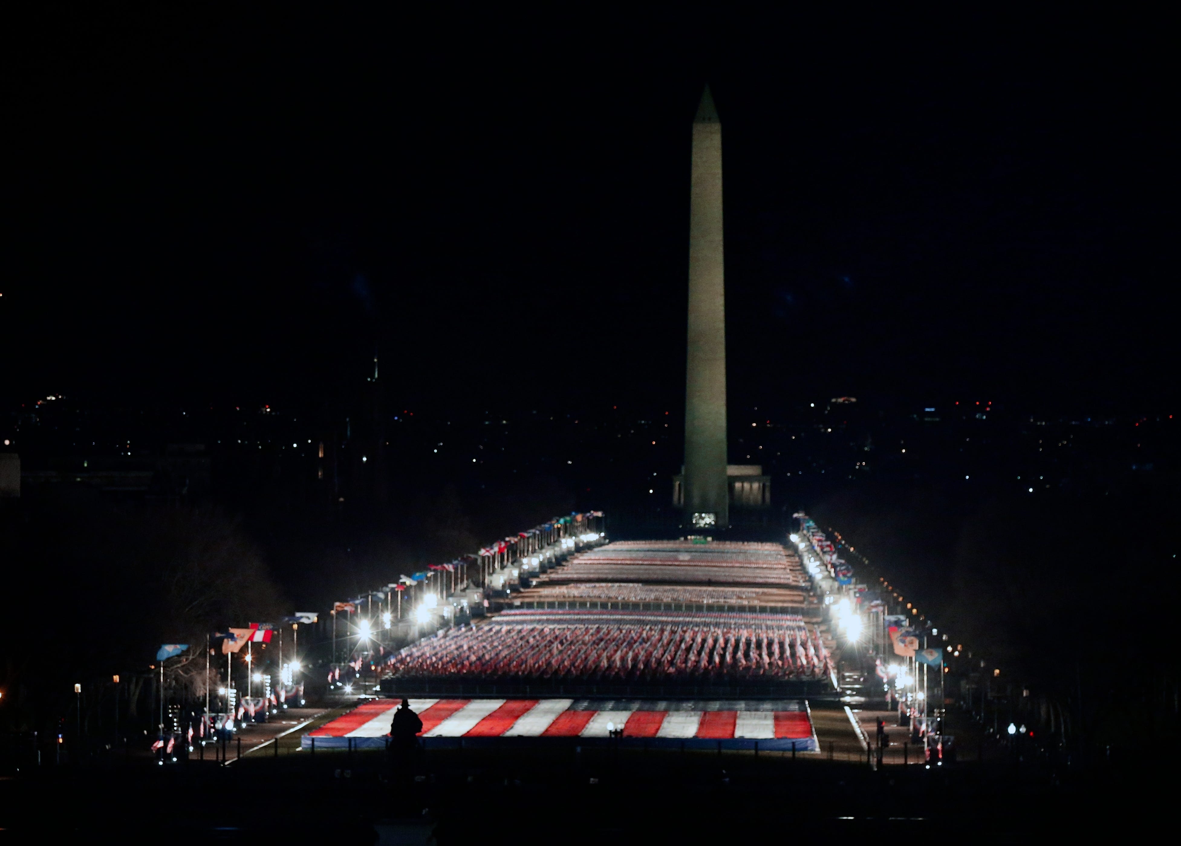 The National Mall is illuminated before dawn prior to the 2021 Presidential Inauguration of President Joe Biden and Vice President Kamala Harris at the U.S. Capitol. 