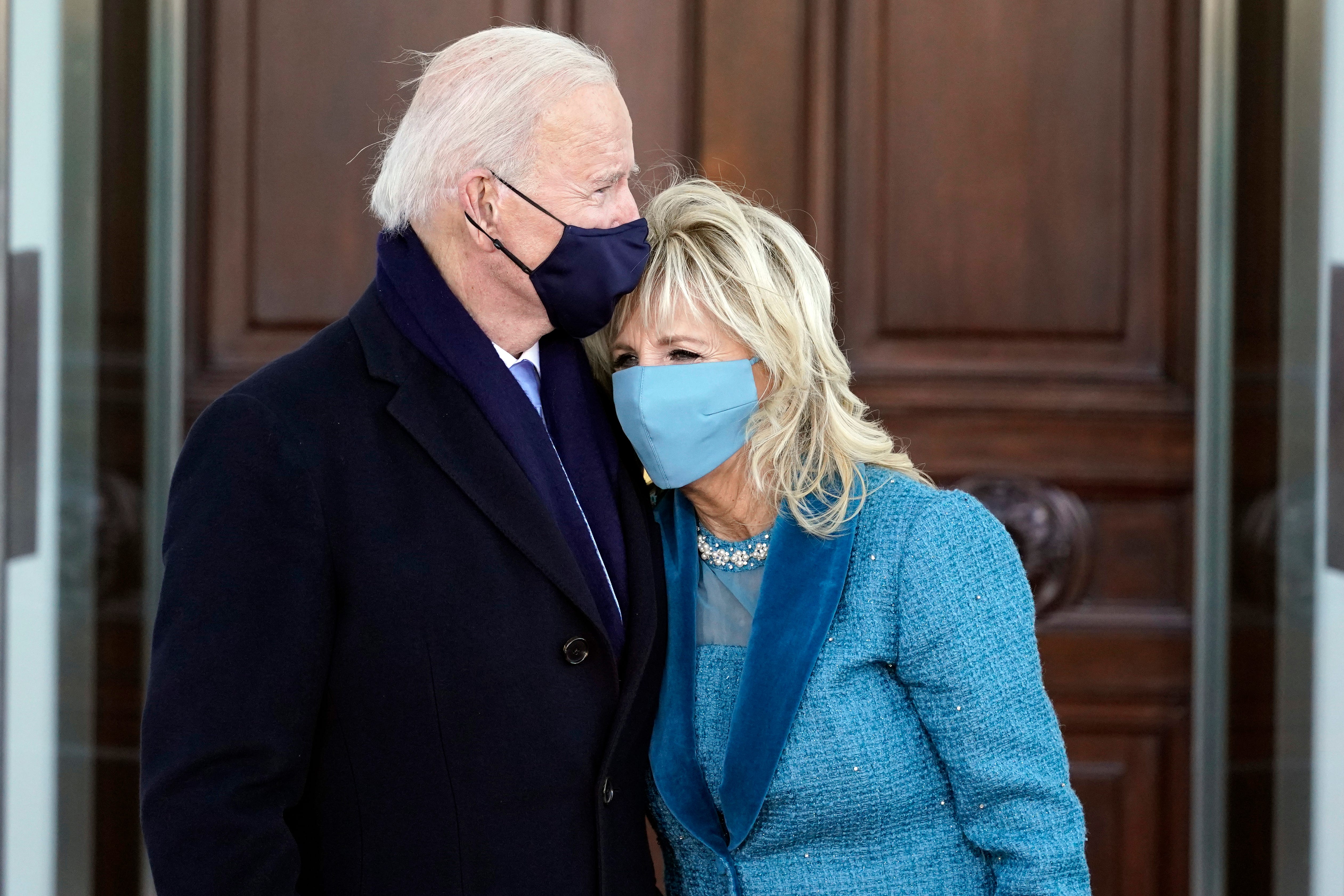President Joe Biden and first lady Jill Biden hug as they arrive at the North Portico of the White House, Wednesday, Jan. 20, 2021, in Washington.