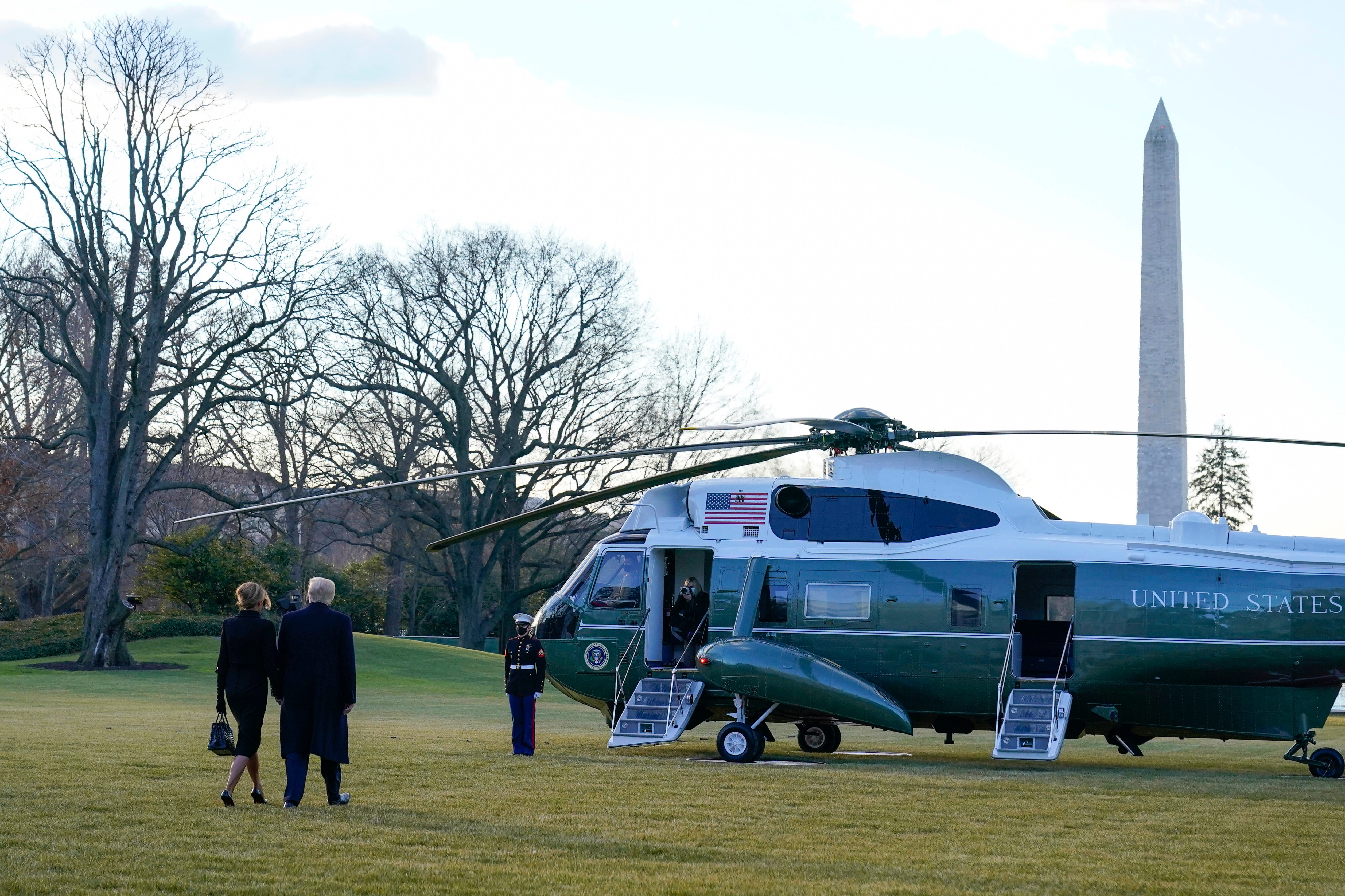 President Donald Trump and first lady Melania Trump walk to board Marine One on the South Lawn of the White House, Wednesday, Jan. 20, 2021, in Washington. Trump is en route to his Mar-a-Lago Florida Resort.